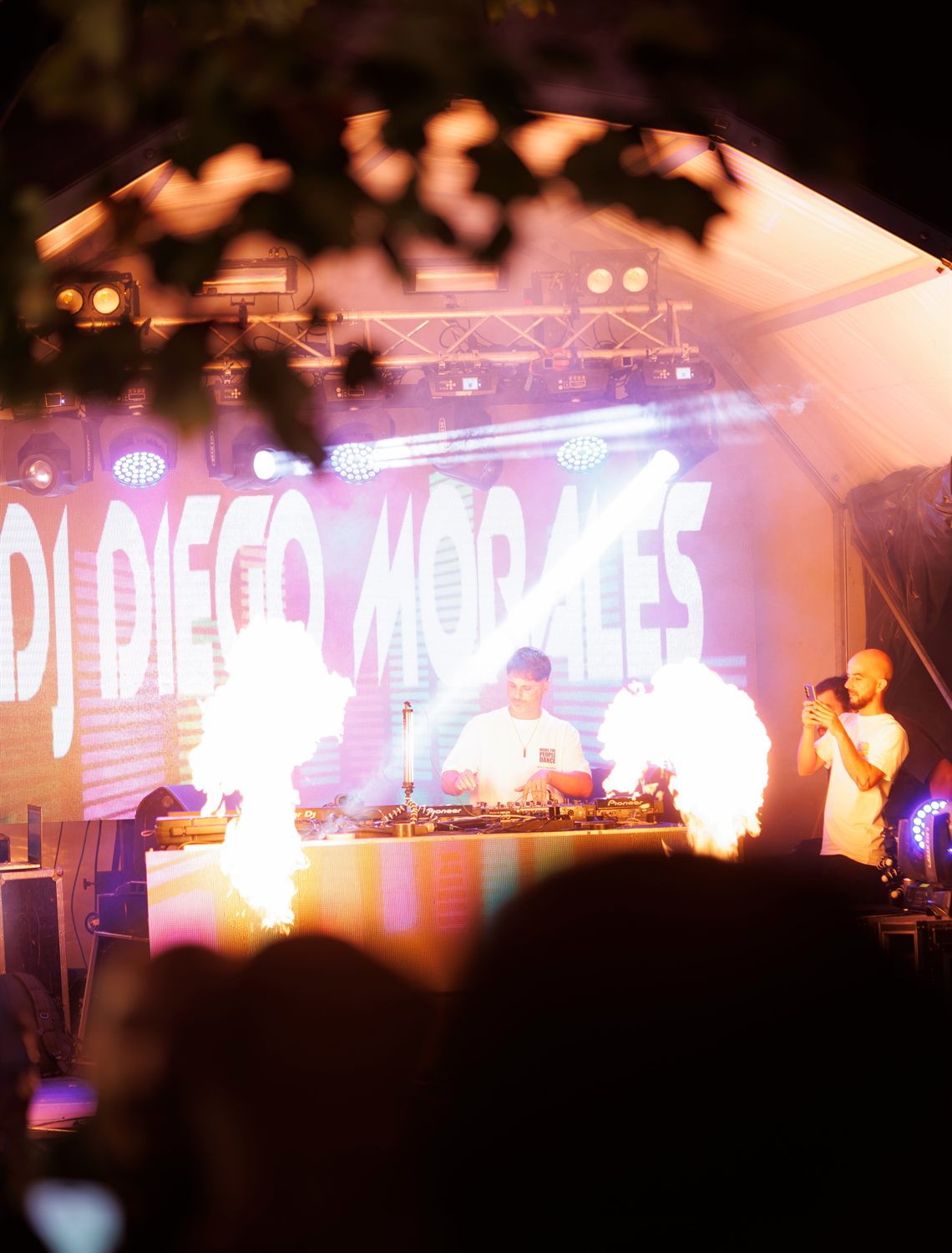 DJ Diego Morales em palco de festival com chamas e público